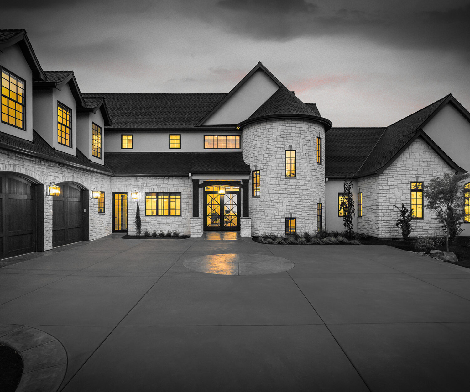 Beautiful Luxury Home Exterior at Twilight with Colorful Sunset Sky