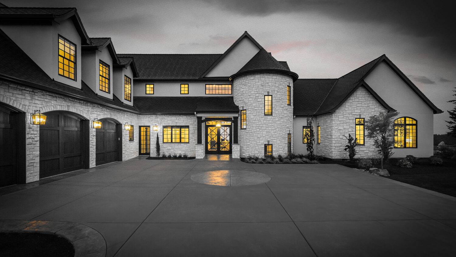 Beautiful Luxury Home Exterior at Twilight with Colorful Sunset Sky